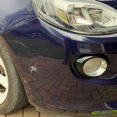 Scuffed blue car bumper