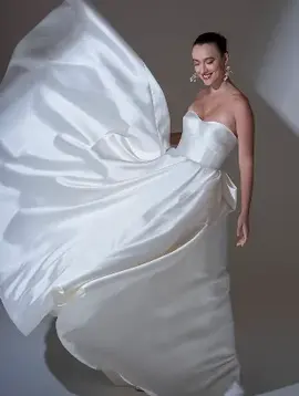 Smiling woman in flowing white wedding gown