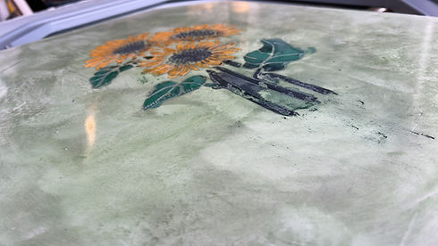 Sunflowers painted on green textured surface
