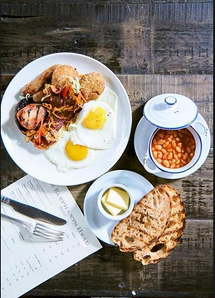 Full English breakfast with eggs, bacon, beans, and toast
