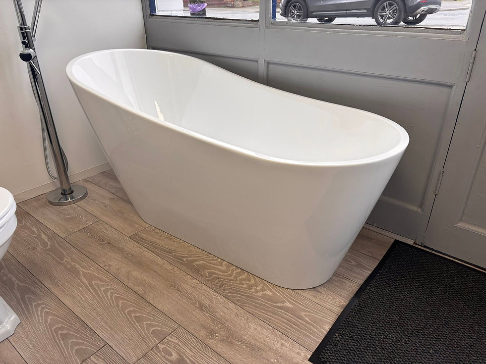A man inspects a glass shower divider in a modern bathroom setting.