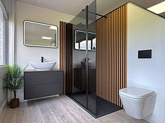 Modern bathroom with freestanding bathtub, glass shower, wooden vanity unit, and large windows.