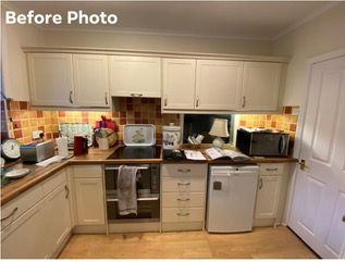 Before photo of a kitchen with light cabinets and orange tile backsplash
