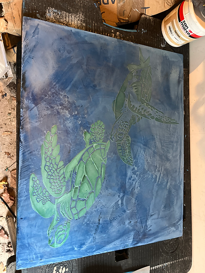 Two green sea turtles on blue artwork