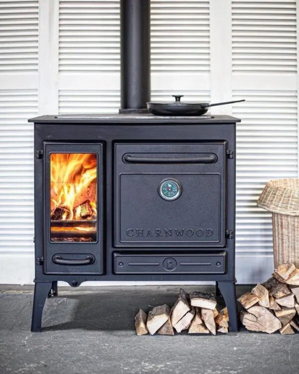 Thumbnail: Charnwood Haven 6.6kW Cook Stove with burning logs and pan.