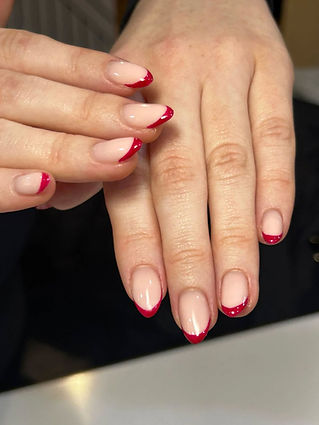 Red French manicure on almond-shaped nails.