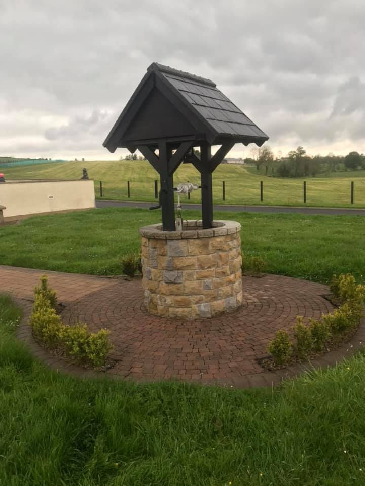 Wishing well with stone base and dark roof