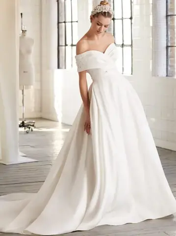 Off-the-shoulder bridal gown with a full skirt