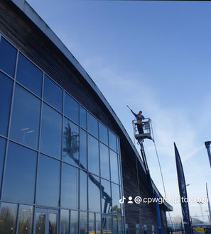 Worker on lift performing commercial exterior cleaning