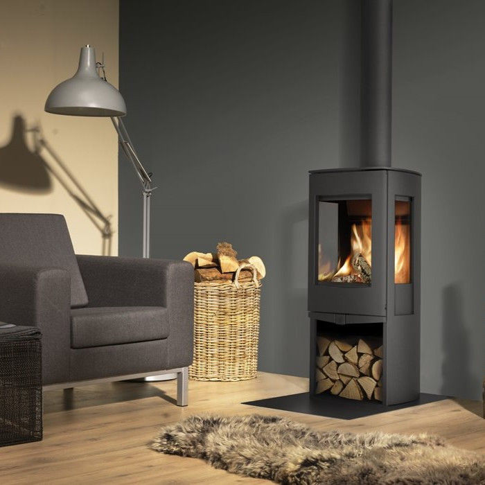 Dik Geurts Folke wood burning stove with logs in a living room