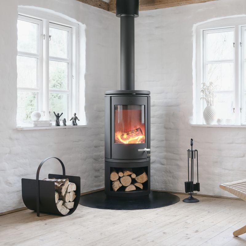 Morsø wood burning stove with classic fire tools.