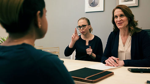 Sign language interpreter assisting in a meeting.