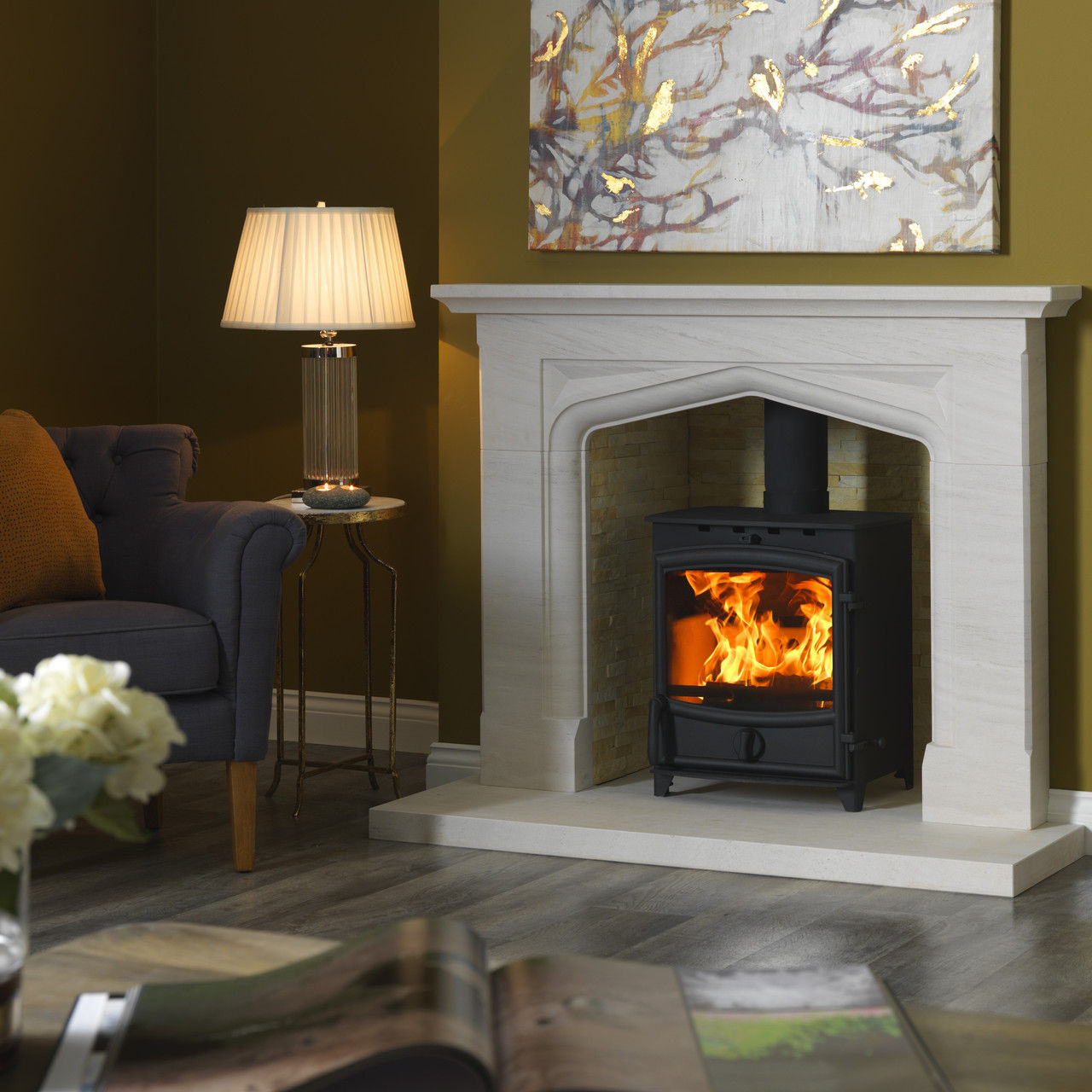 Fireline FX8 multi fuel stove in a stone fireplace.