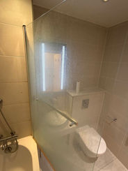 Modern bathroom with toilet, glass shower, and bathtub