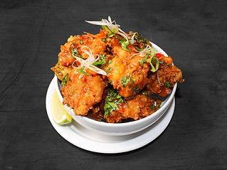 Crispy fried chicken bites with herbs and lime