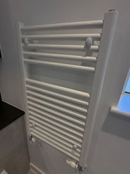 White towel radiator on a wall
