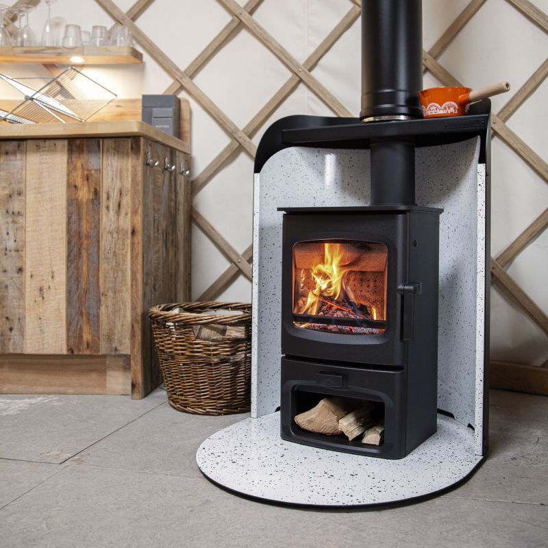 Charnwood Stove Pod with a burning wood stove in a yurt.