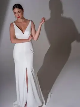 Woman in white v-neck gown with slit