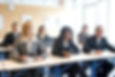 Professionals attending executive assistant training in a classroom