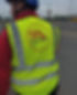 Worker in yellow high-vis vest with 'SPL ELECTRICAL SOLUTIONS' logo