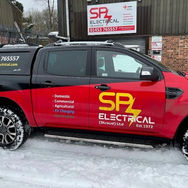 Red and black SPZ Electrical truck, 01844 299333, spzelectrical.com, parked in snow