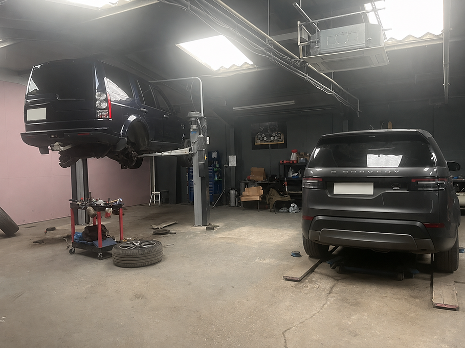 Car on a hydraulic lift for engine fault finding.