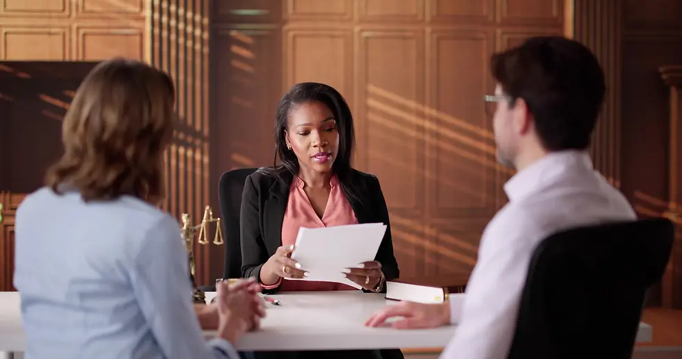 Mediator discussing documents with a couple in a law office.
