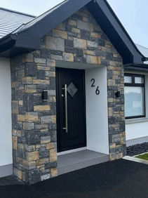 Modern house entrance, black door, stone, number 26