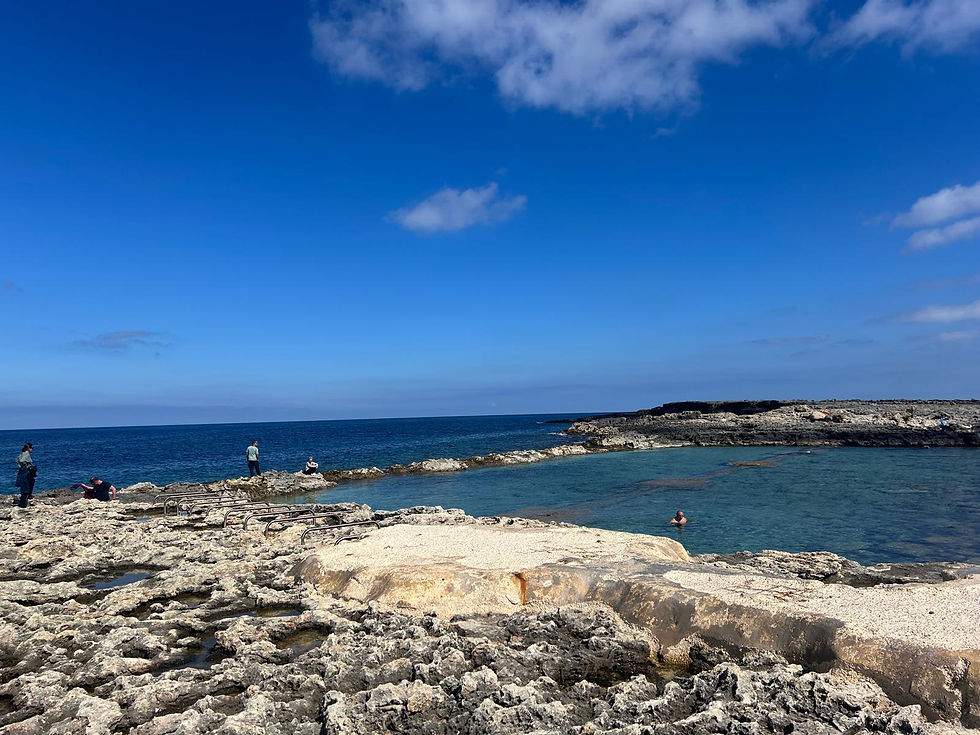 Fra Ben Bay sandy beach in Qawra Malta with calm shallow water ideal for families.