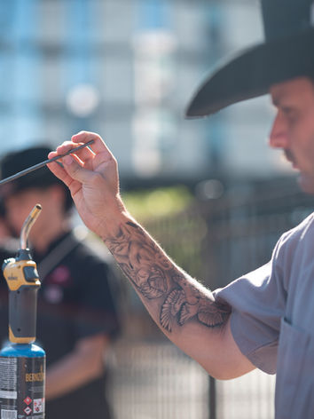 Professional shaping a hat at a hat bar for events.