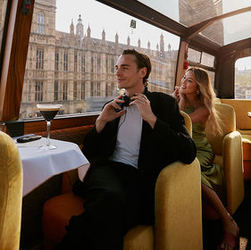 Man and woman seated on Le Grand bus
