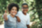 two boys giving thumbs up