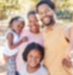 mom, dad, and two children smiling