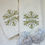 Thumbnail: striped towel with custom embroidered monogram in the form of snowflake and name, together with a handmade soap in the form o