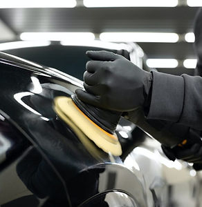 professional-detailing-a-car-in-car-studio-hands-with-orbital-polisher-scratching-remover-