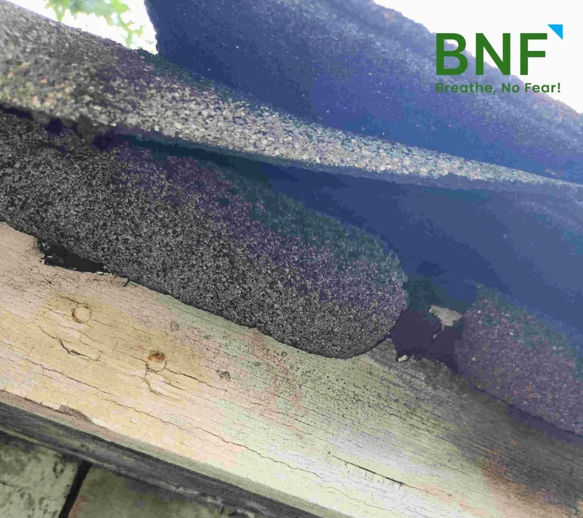Asbestos-containing roofing material exposed due to damage in a residential property in Hudson County, NJ, inspected by an asbestos inspector from BNF Consulting NJ for asbestos testing.