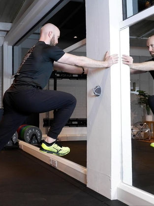 Mark Stanton doing a Wall Drill, Strength Training for Running in Fulham