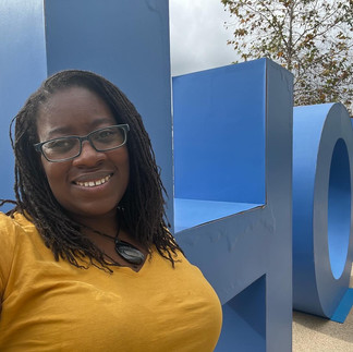 Black Midwife posing in front of Hope Sculpture