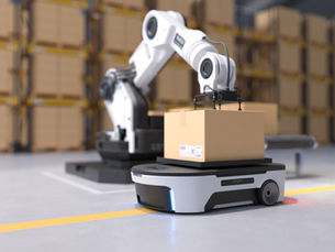 An industrial robotic arm loading a package onto an autonomous mobile robot