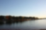 A sunset view of South Cove County Park, overlooking the water and facing the shore full of RVs and boats.