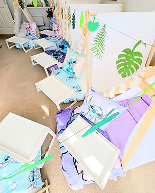 Lilo and stitch themed sleepover tents, stitch cushions, tropical bunting, purple bedding