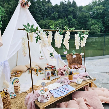 Kids corner, teepee, bunting flowers, wooden table, toys
