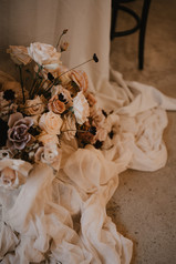 luxe draped wedding ceremony with chocolate mocha and toffee toned florals and candles