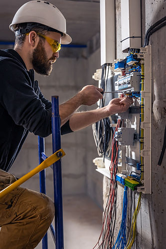 male-electrician-works-switchboard-with-electrical-connecting-cable (1).jpg
