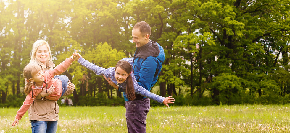 young-familiy-are-walking-through-green-field.jpg