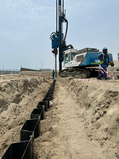 installing vinyl sheet piles in sandy soil under clear desert conditions.