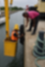 Marine infrastructure personnel install a quay wall fender system from an elevated work platform, enhancing vessel berthing safety and port asset protection.
