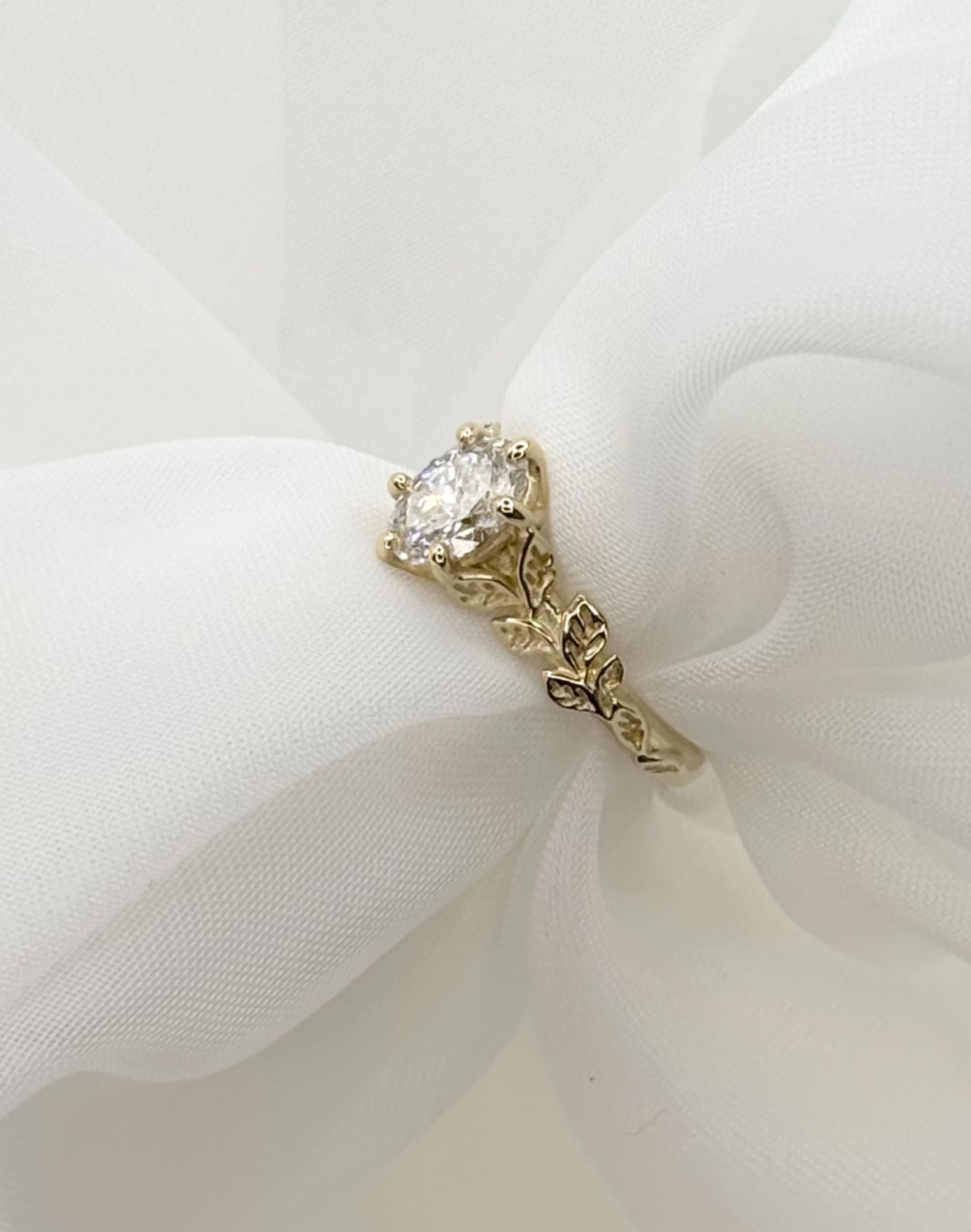 A modern lab-grown diamond solitaire engagement ring set in polished 18ct yellow gold.
