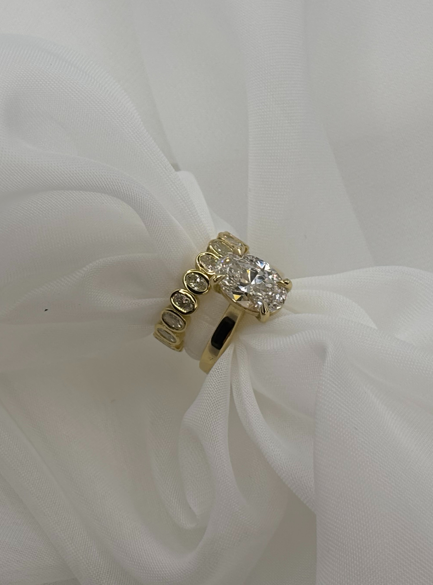 An intricate engagement ring design featuring a natural diamond and detailed metalwork.