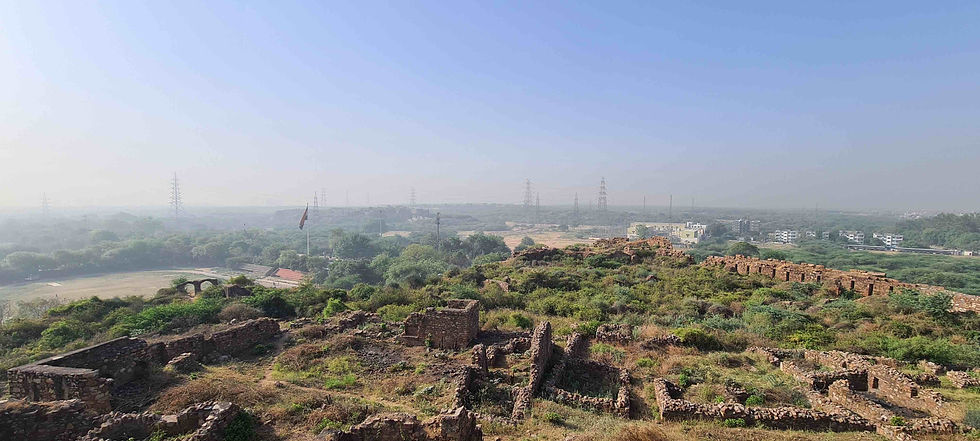 fort ruins in a city with another fort visible through the haze at a distance